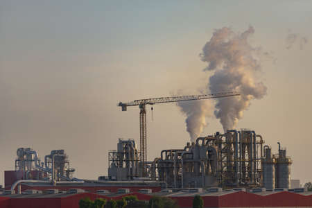 Factory in the east of Italy. Factory at sunset with pipes and crane.の写真素材