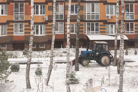 Moscow. Russia. Winter 2020. Tractor removes snow from the yards after a snowfall.のeditorial素材