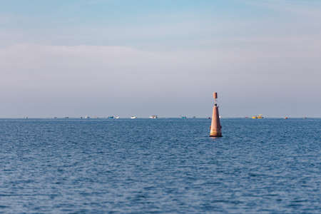 Sea sign on the buoy indicating the fairway. The red mark the entrance to the Bayの写真素材