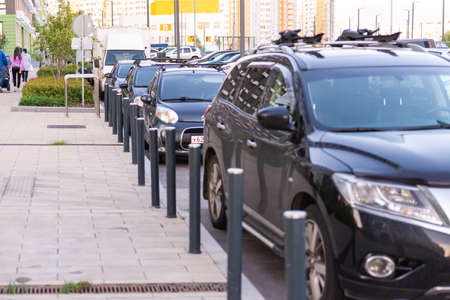 Car parking poles. Cars are parked parallel to the houses.のeditorial素材