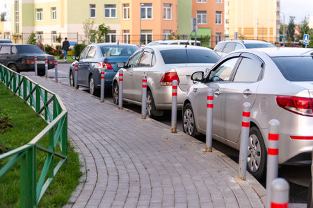 Car parking poles. Cars are parked parallel to the houses.のeditorial素材