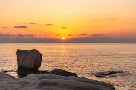 Sunset draws a sunny path on the sea among the rocks.の写真素材
