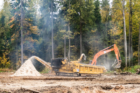 Moscow oblast. Russia. Autumn 2019. Industrial wood chopper at work. Construction of a large...
