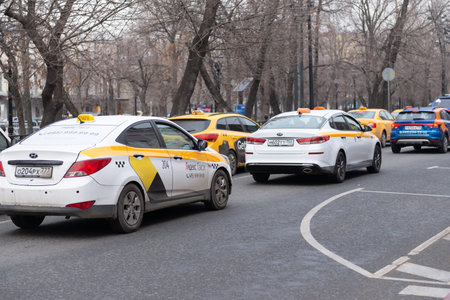 Moscow. Russia. Spring 2019. A street where there are many cars taxis of different companies.