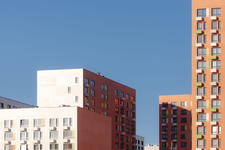 High-rise buildings under the bright sun. New areas of Moscow are growing up. Houses against a...