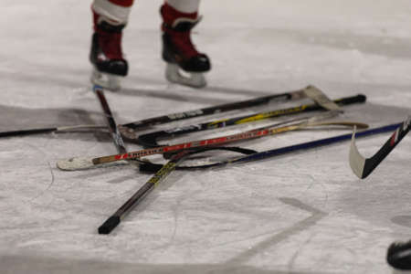 Ural, Russia, Winter 2020. Players are divided into teams. Hockey sticks on the rink.のeditorial素材
