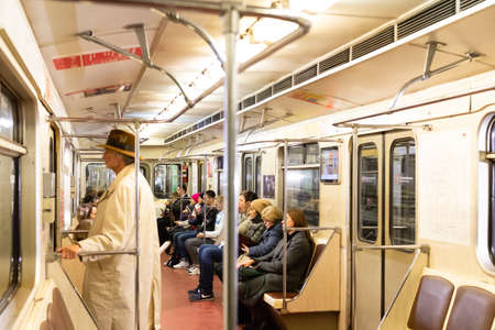 Moscow. Russia. Autumn 2019. People ride in a subway car. Retro train runs on the red line in Moscow.のeditorial素材