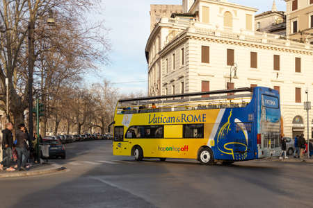 Rome, Italy. Spring 2020. Tourist bus on the streets of Rome. A double-decker bus without a roof takes tourists to places of interest.のeditorial素材