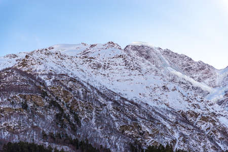 Elbrus region in the sunlight. Glacier and forest on the mountainside.の写真素材