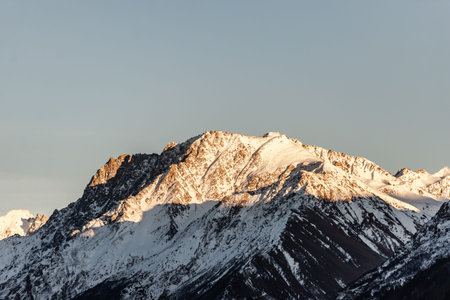 Elbrus region in the sunlight. A very large mountain in the light of the setting sun.
