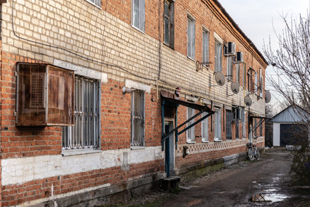 The village of Khanskaya. Russia. Winter 2020. Courtyard of an old apartment building. House on...
