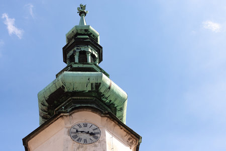 Church spire with clock.The spire of the Bratislava Cathedral against the blue sky.