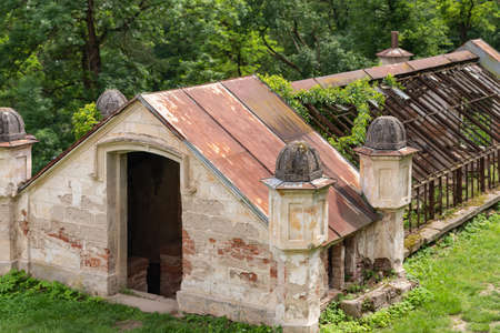 Ruins of an ancient greenhouse. The skeleton of an old heated greenhouse for growing vegetables.の写真素材