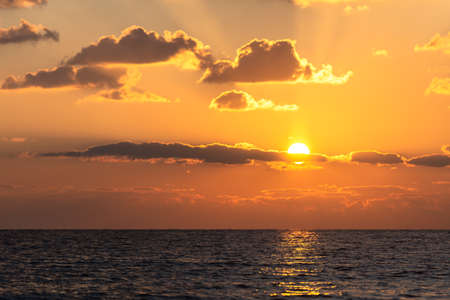 Beautiful winter sunset in Cyprus. Orange colors of the low sun in the Mediterranean Sea.の写真素材