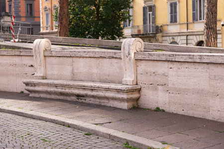 A bench on the street of Rome. An old stone bench in one of the squares of Rome.の写真素材