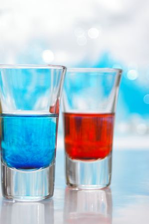 Blue and red liquid in glasses.の写真素材