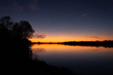 Sunset on the bank of the Po riverの写真素材