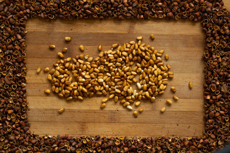 Cedar nut kernels, cedar nut shells. Cedar nut on wooden background.