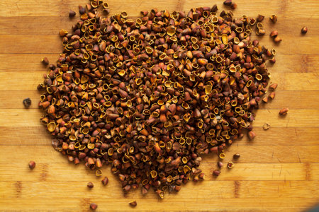 Cedar nut kernels, cedar nut shells. Cedar nut on wooden background.の写真素材