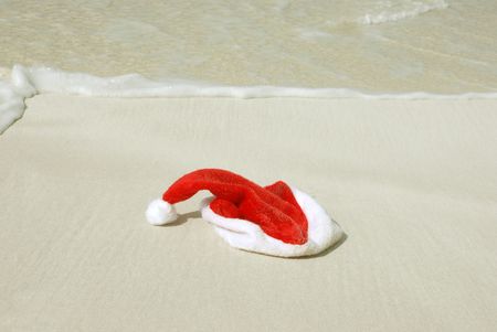 Santa's hat on a sandy beachの写真素材