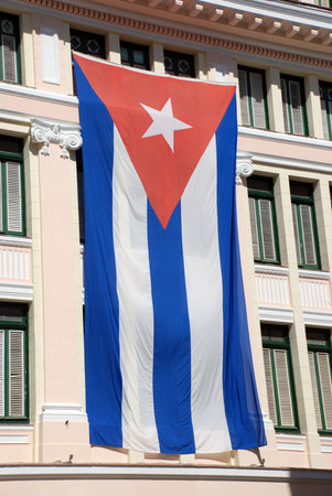 Facade of Old Havana building with cuban flagの写真素材