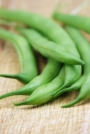 Green beans on a wooden board close upの写真素材