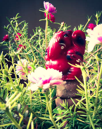 Lord Ganesha sculpture portrait picture with flower in the background. The background is intentionally bluredの写真素材