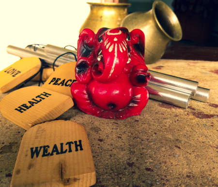 Red ganesh deva sculpture portrait picture with pots and Bells in the background. Lord Ganesh is one of the important and prestigious figure in Hindu mythologyの写真素材