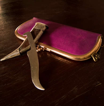 Knife with ladies purse. The picture features a knife which is used by Sikhs as a weapon for self defence and is also known as'kirpan'.The purse depicts women empowerment and self defence.の写真素材