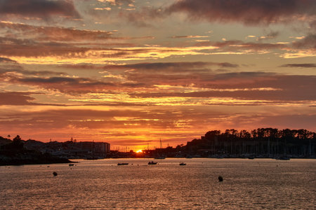 Sunset with a completely red sky with the Baiona fonde from Ladeira beach, Baiona, Pontevedra, Spainの写真素材