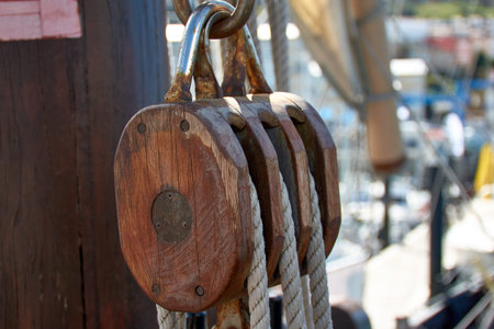 Pulley for sails and ropes made of wood on the replica of the Santa Maria caravel, with the sail and...