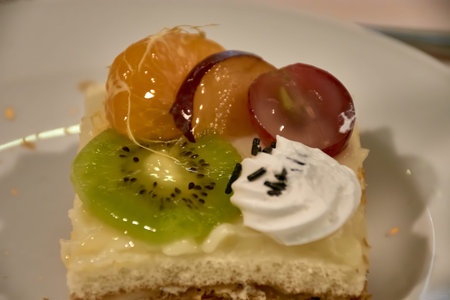 Fresh Mixed Fruit Tarts ready for dessert on the plate. Delicious sweat cake with kiwi, grape,...