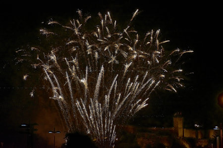 Spectacular fireworks display during the Fiesta de la Anunciada in Bayona, with the historic Parador...