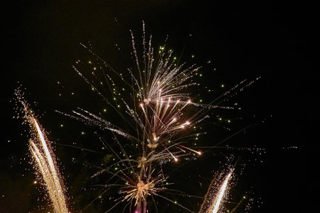 Spectacular fireworks display during the Fiesta de la Anunciada in Bayona, with the historic Parador providing a stunning backdrop. The vibrant explosions of color light up the night sky, creating a mesmerizing visual feastの写真素材