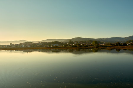 The elevated vantage point from the campsite offers a sweeping view of this natural wonder, where the meeting of river and sea creates a picturesque and serene landscape. This scene perfectly captures the beauty and tranquility of Galicia's coastal environment, making it a must-see for nature enthusiasts and campers.の写真素材