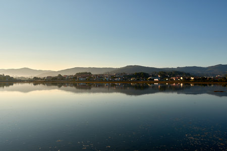 The elevated vantage point from the campsite offers a sweeping view of this natural wonder, where the meeting of river and sea creates a picturesque and serene landscape. This scene perfectly captures the beauty and tranquility of Galicia's coastal environment, making it a must-see for nature enthusiasts and campers.の写真素材