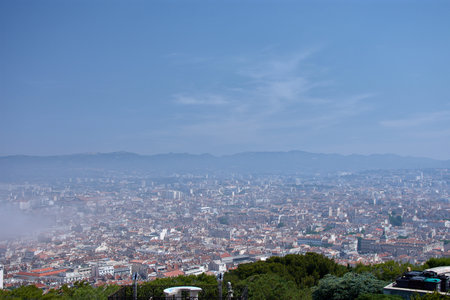 From the viewpoint of Notre Dame de la Garde, the city of Marseille stretches out under a morning...