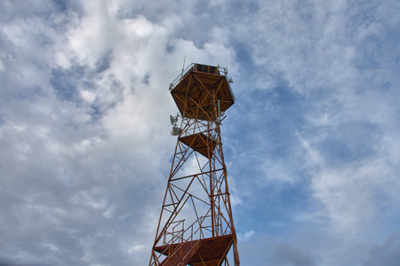 An old rusty metal watchtower now stands as a telephone antenna in Pla de la Font, Lleida,...