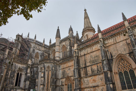The Batalha Monastery, with its complex Gothic ornamentation and Manueline elements, with pointed...