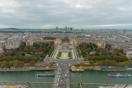 From the top of the Eiffel Tower, a panoramic view of Paris extends to dusk, with illuminated streets and classic buildings bathed in warm light. The deep blue sky creates a serene atmosphere that enhances the city's elegance. Ideal for illustrating tourism, architecture, urban culture, and night photographyの写真素材