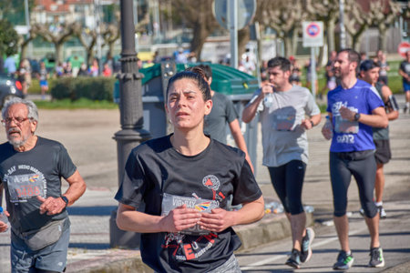 Nigran,Pontevedra,Spain;April 6, 2025;This close-up image captures the energy and determination of runners participating in the annual Vigo-Bayona half marathon as they pass through Nigran, Spain. The photo highlights the intensity of the race and the effのeditorial素材
