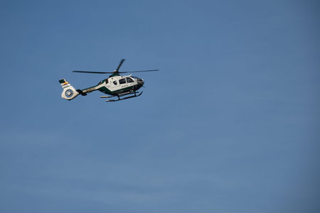 Bayona,Galicia, Spain, February 28, 2026,A Civil Guard helicopter, recognizable by its distinctive green and white livery, nimbly soars through the clear skies of Baiona during a coastal surveillance mission. The composition highlights the aircraft in motのeditorial素材