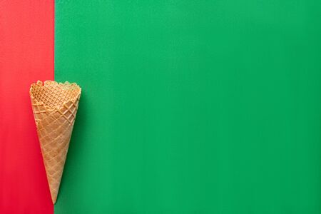 Top view at the empty waffle cone on red and green background, special concept, enough place for textの写真素材