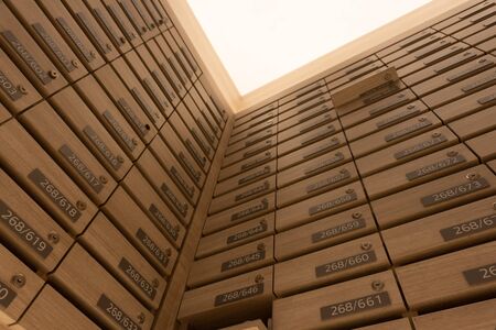 Numbered mailboxes and lockers in raw in the condo. Natural wooden letterbox panel pattern , view from bottom, from down into upの写真素材