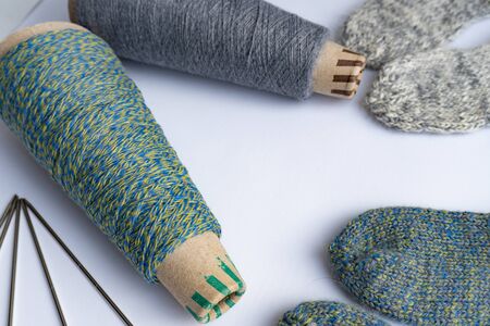 Socks, thread, needles are on white background, isolated, knitting concept.の写真素材