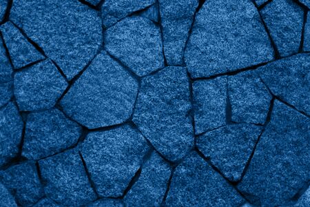 Stone wall toned in blue is a good background.の写真素材