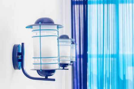 Classic blue three lamps on white wall in the room inside. Trend, the color of the year.の写真素材