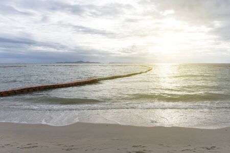 Sunset or sunrise with the view of calm and no waves sea with modular floating pontons and sand at asian resort at summer. Good backgroundの写真素材