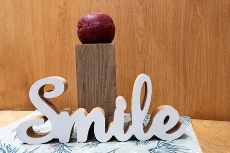 Word smile from wooden letters on table in interior. Enough space for text.の写真素材
