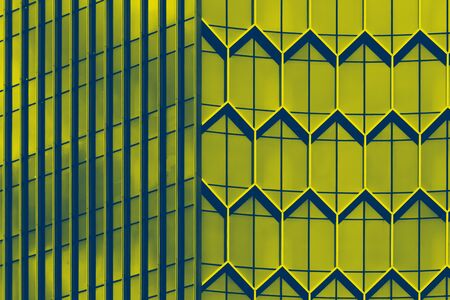 View at the bussiness building with geometric architecture glasses, toned in green, art deco. Close up. Urban life, minimalistic concept.の写真素材
